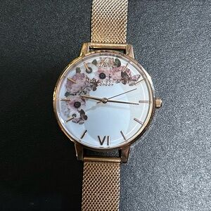 OLIVIA BURTON WATCH WITH 38mm WHITE MULTICOLOR FLORAL PATTERN FACE.